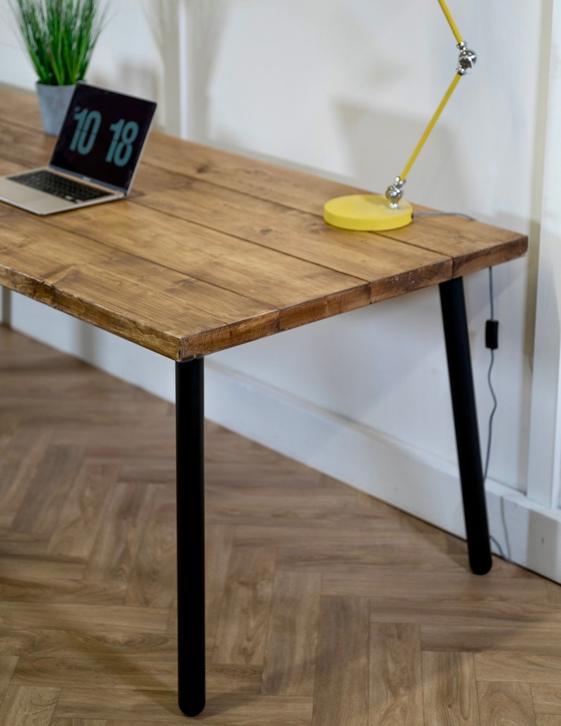 Wooden desk with black metal outlet legs